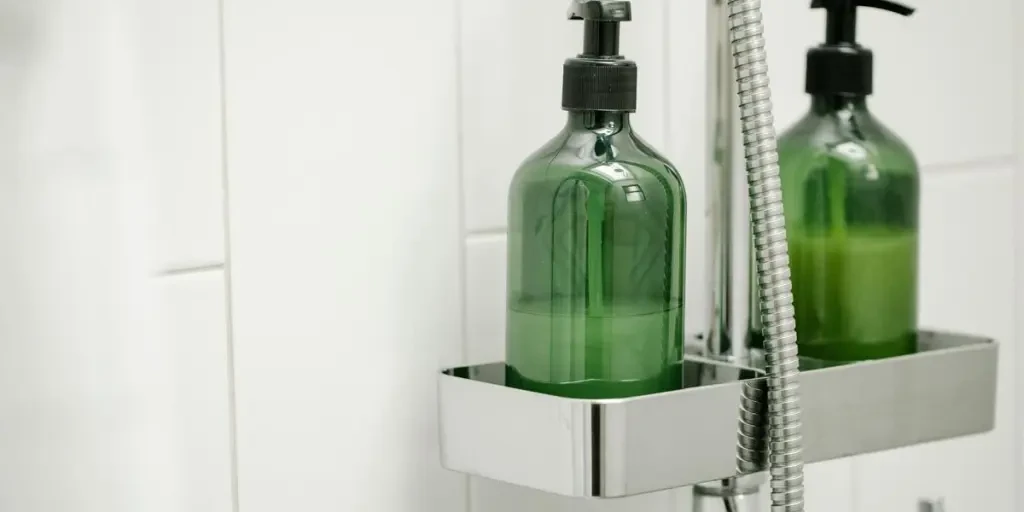 Green eco-friendly shower bottle in a modern bath setting. Clean and minimalist desig