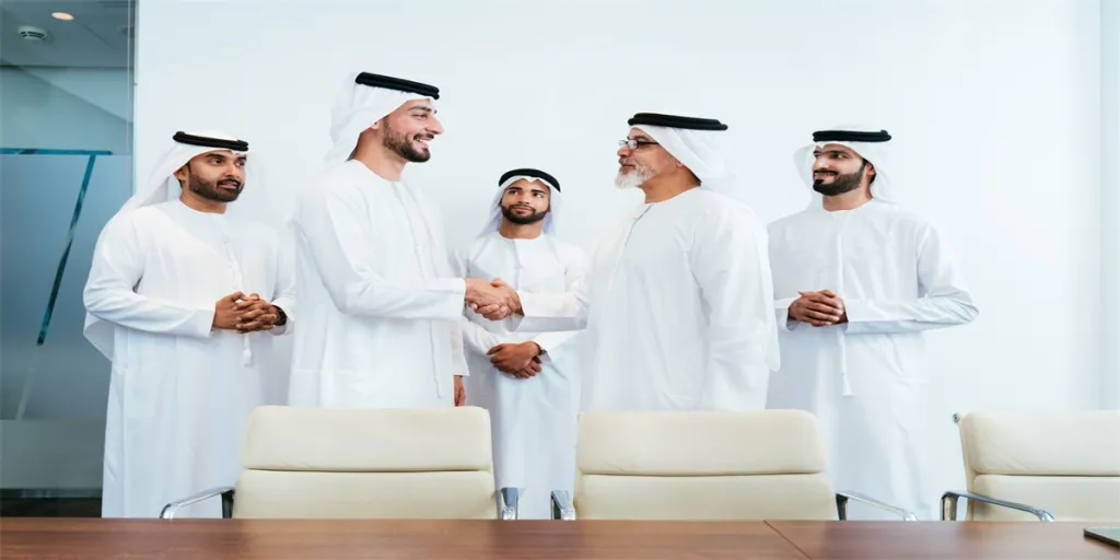 Group of corporate arab businessmen meeting in the office - Middle-eastern businesspeople wearing emirati kandora working in a meeting room