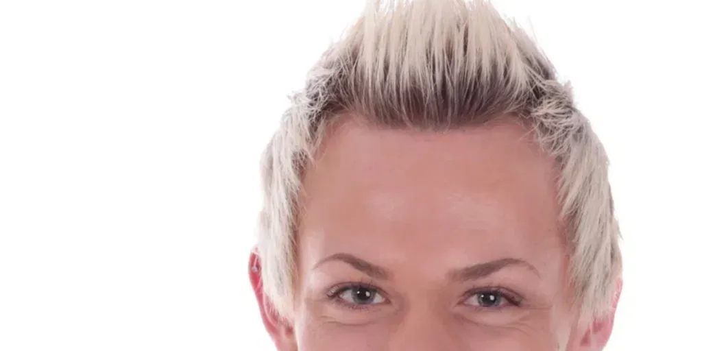 Handsome young man with a fresh, hip hairstyle on a white background