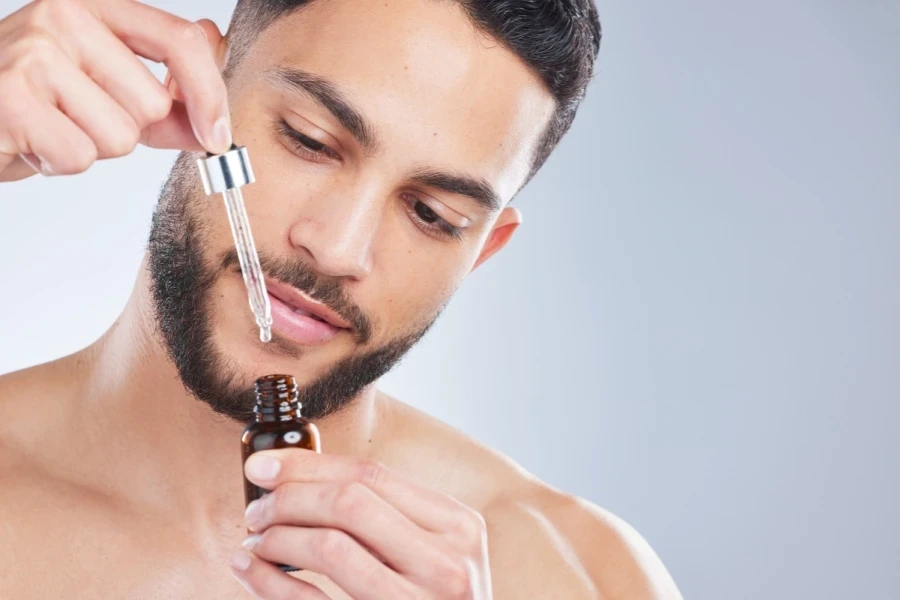 Man holding bottle of retinol serum for crows feet