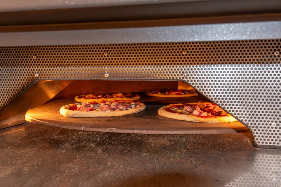 Multiple pizzas cooking in an electric oven