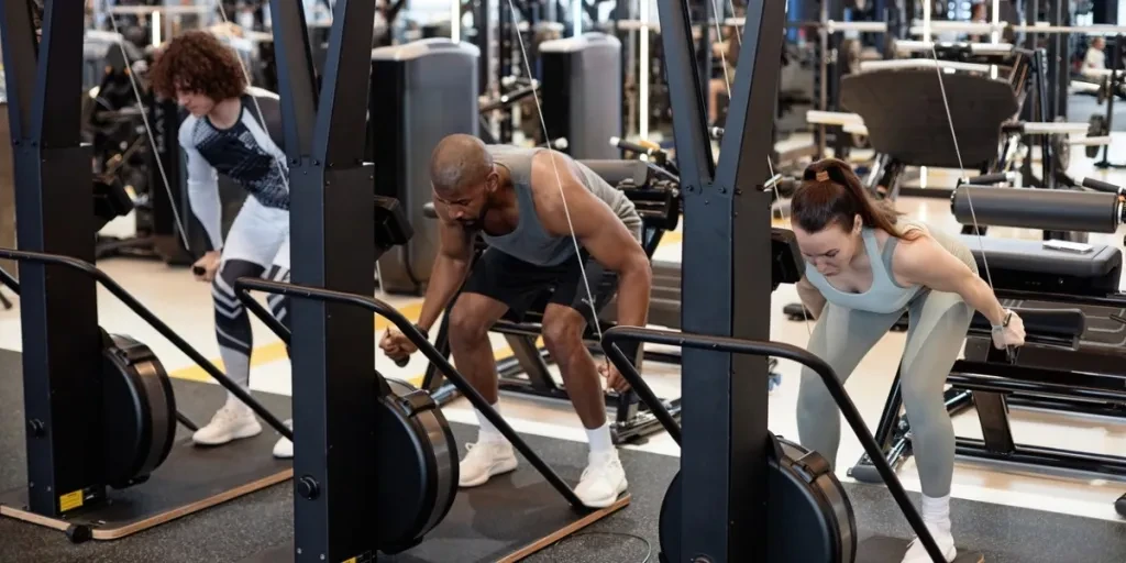 People using exercise machines in gym