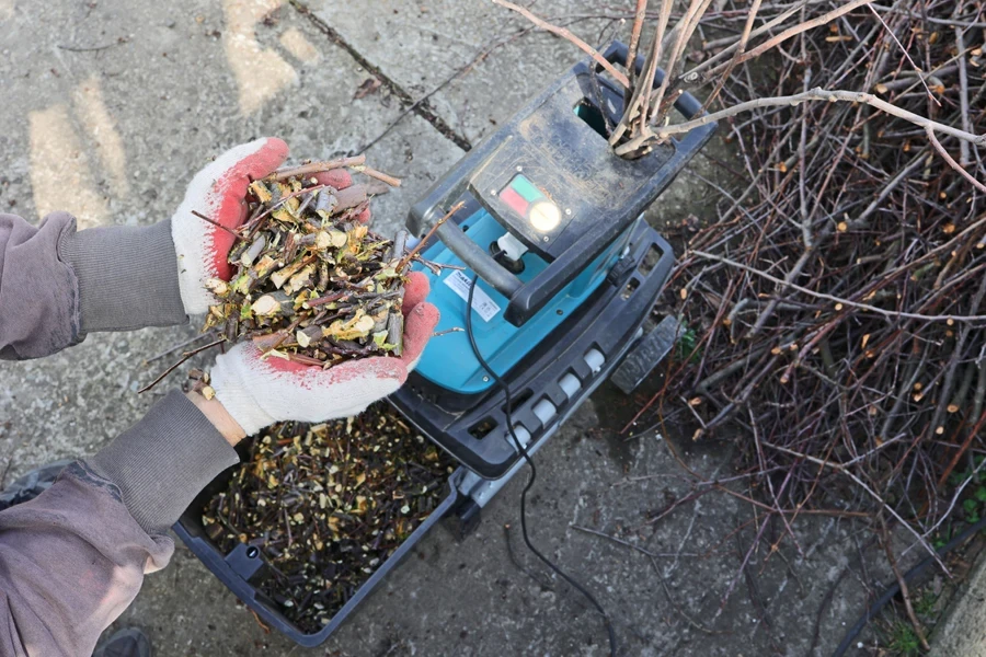 Person examining the material processed using a shredder