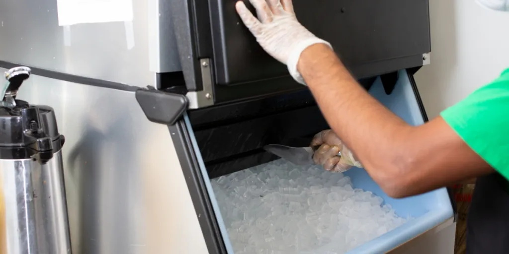 Person getting ice from a commercial ice machine