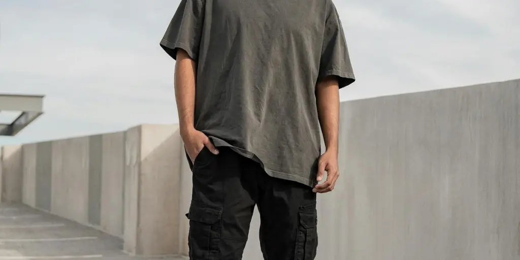 Portrait of a young man standing confidently in an outdoor urban environment