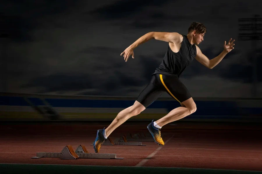 Professional sprinter training at the stadium in the evening