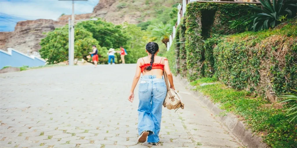 Rear view of tourist girl walking on the street