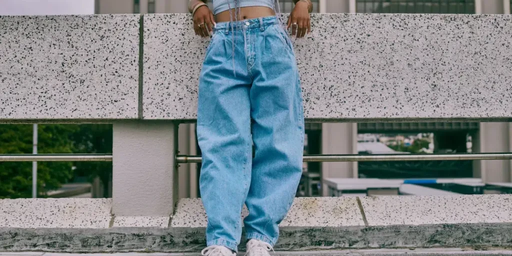 Shot of a trendy unrecognisable woman leaning against a wall in the city