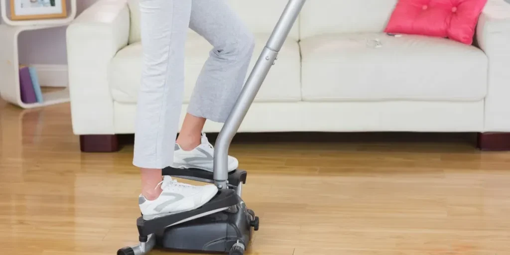 Sporty woman exercising on step machine in bright living room