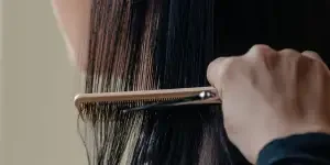 Stylist Combs Through Long Hair