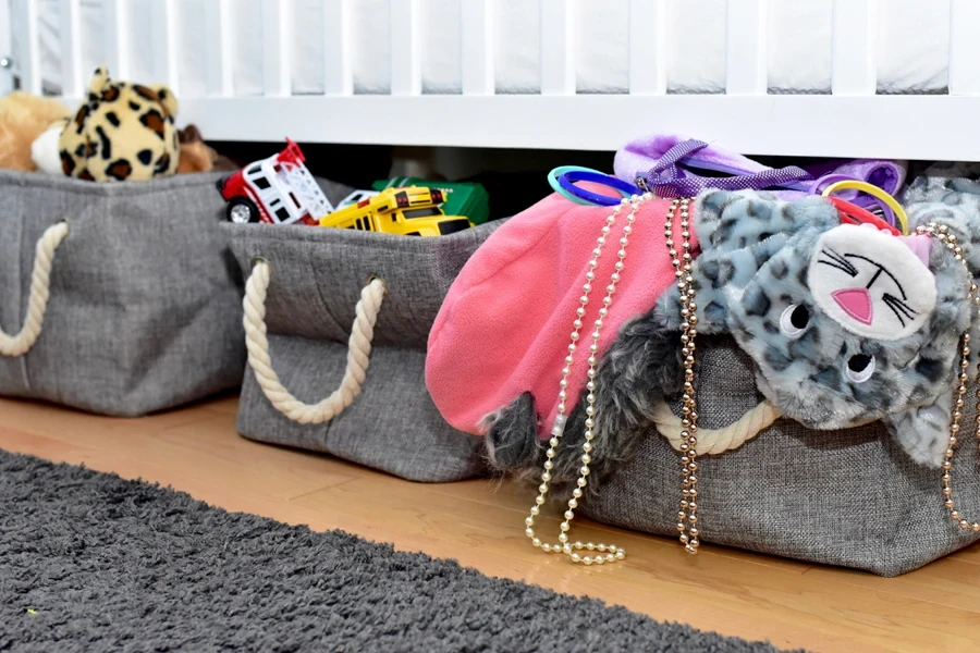 Three under-bed storage bins packed with stuff