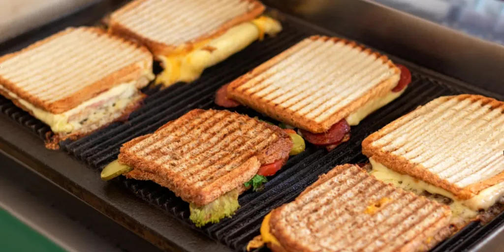 Toasted sandwiches with melting cheese on toaster or grill.