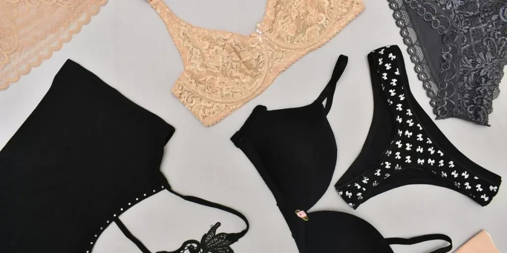 Top view of lingerie products including bras, panties, and a crop top. These products are actually available at victress.pk