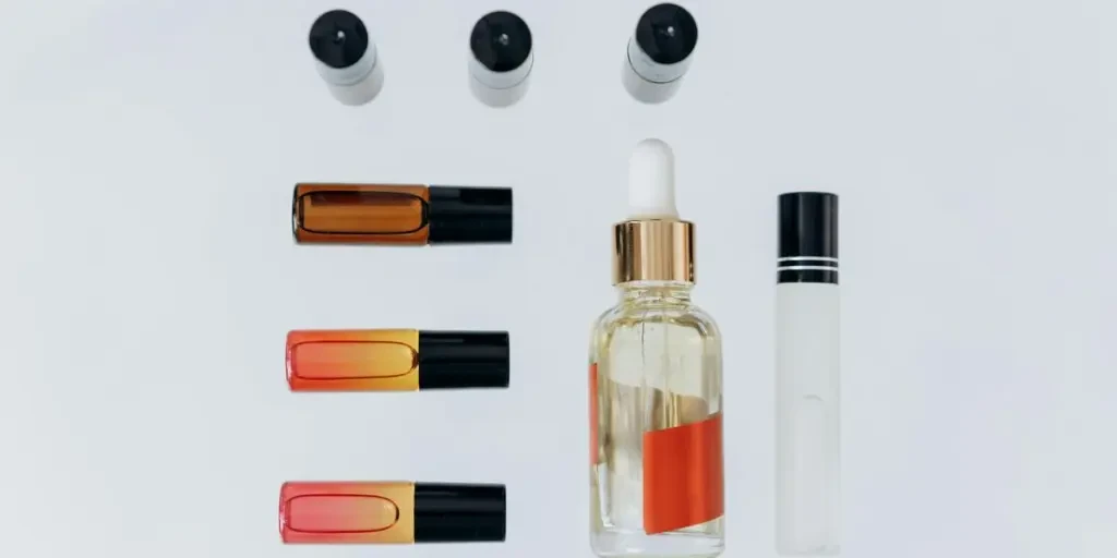 Top view of various aromatherapy oils and bottles arranged on a white background