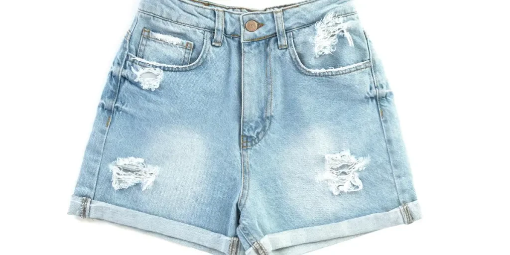 Trendy denim shorts with ripped details on a white background, perfect for casual fashion stock photography