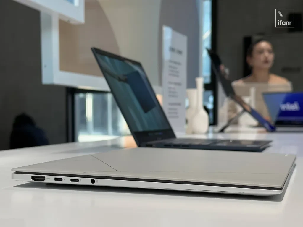 Various Asus Zenbook series laptops displayed on a table.