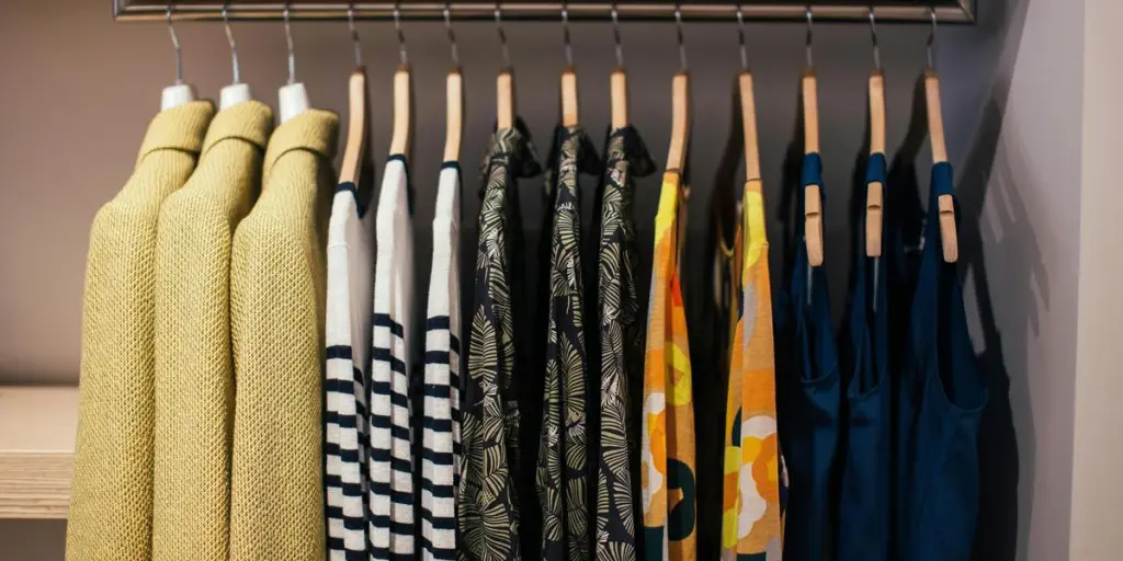 Vibrant clothing collection neatly arranged on hangers in a modern indoor closet