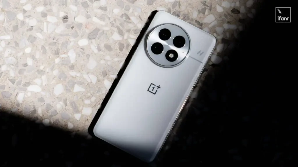 White OnePlus 13 smartphone in hand