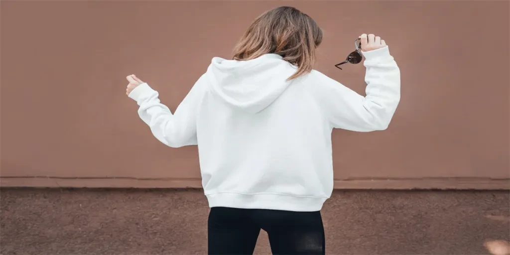 White hoodie on a young woman, back view