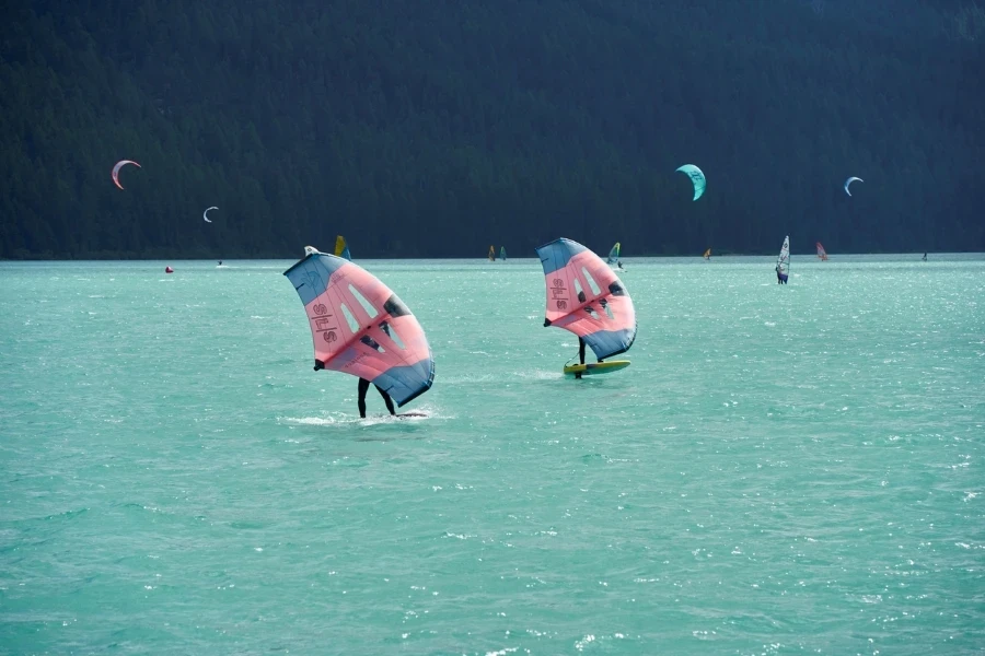 Wing foiling on the lake. Water sports enthusiasts surfing with equipment from duotone