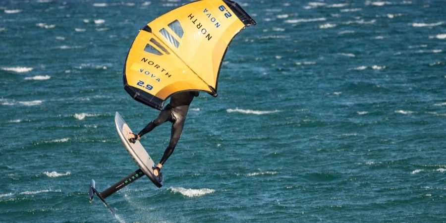 Wingfoiler jumping in windy sea in Tarifa