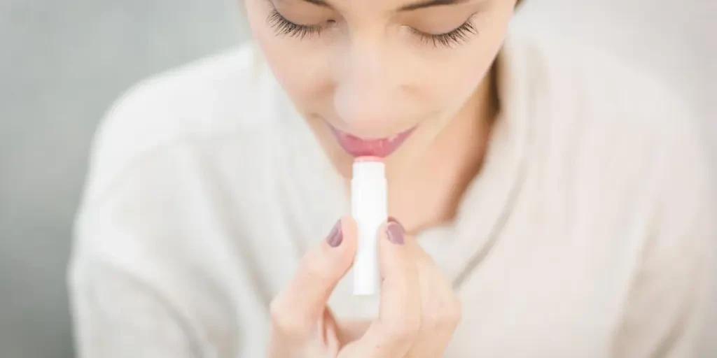 Woman Applying Lip Balm