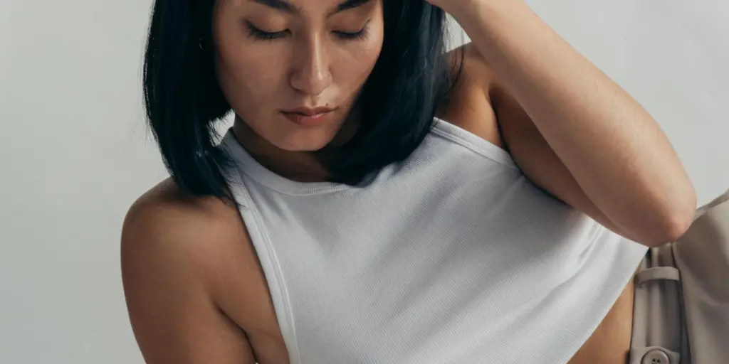 Woman In Cropped White Vest Top