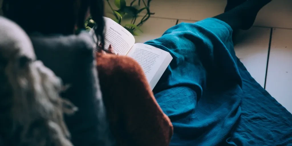 Woman Sits On Floor Reading