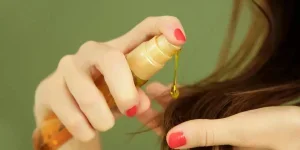 Woman applying oil on hair ends1