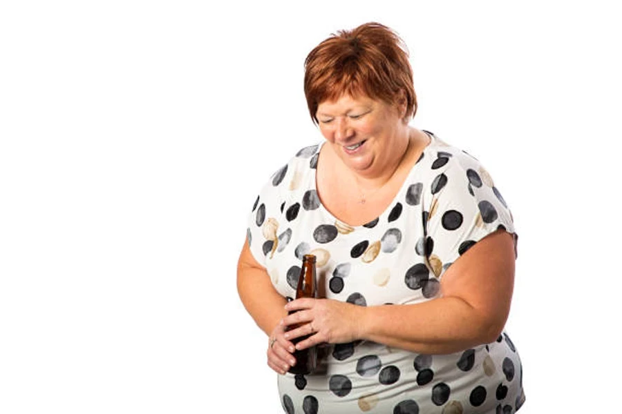 Woman holding glass bottle with red Karen haircut