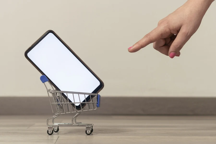 Woman pointing at a phone in a cart