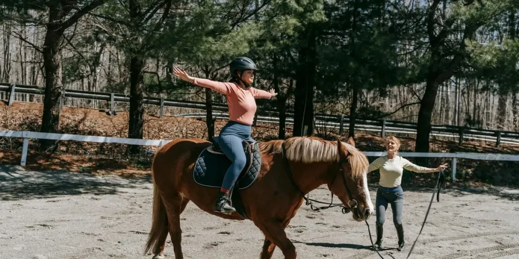 Woman practices riding techniques in a park setting, emphasizing balance and skill development