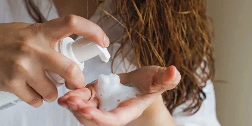 Woman's hand close-up with a styling white foam