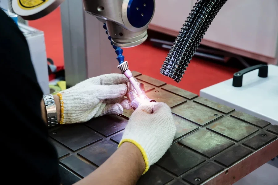 Worker using repair mold and die part by Laser welding machine 