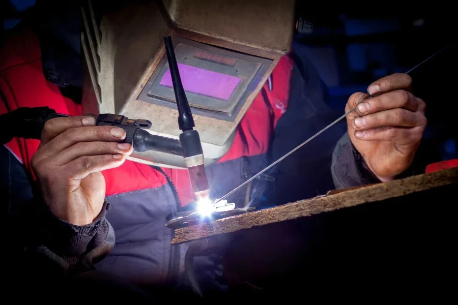 Worker welding the aluminium