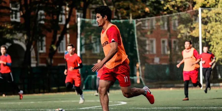 Young athletes playing a competitive soccer match outdoors in a Moscow park