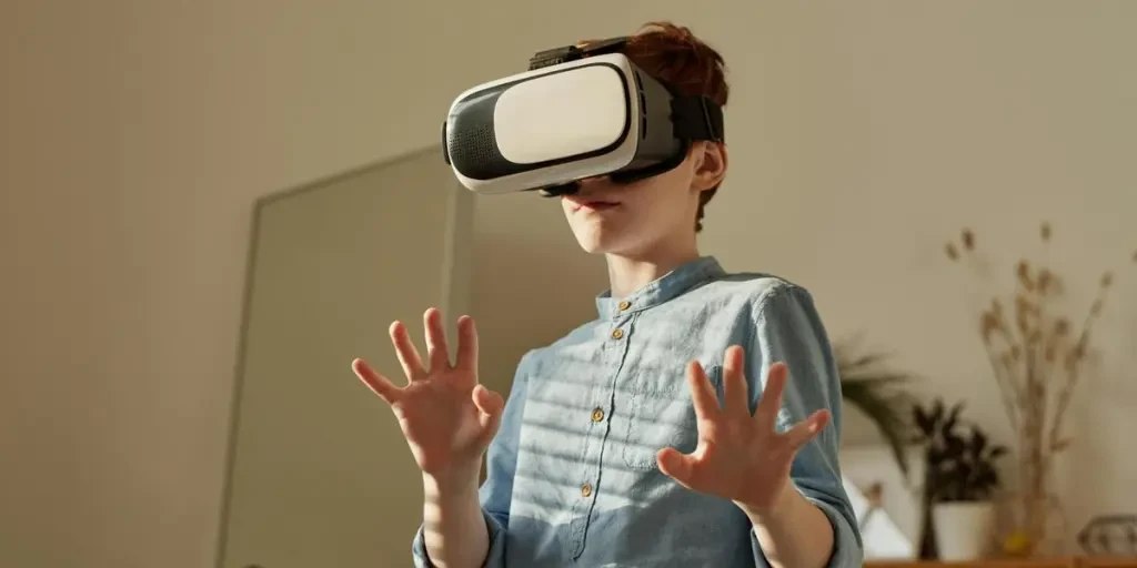 Young boy in blue shirt using VR headset indoors for gaming fun