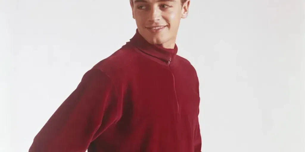 Young man standing against white background