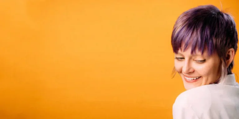 Young woman with cute pixie haircut dyed violet