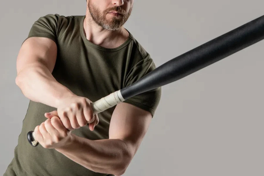 cropped view of angry man express anger with bat isolated on grey background