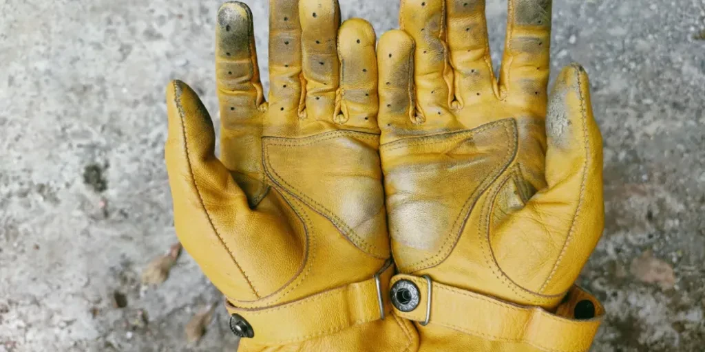 dirty yellow leather motorcycle gloves