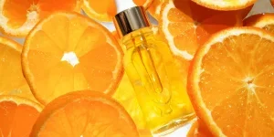 facial serum in a glass bottle with vitamin C