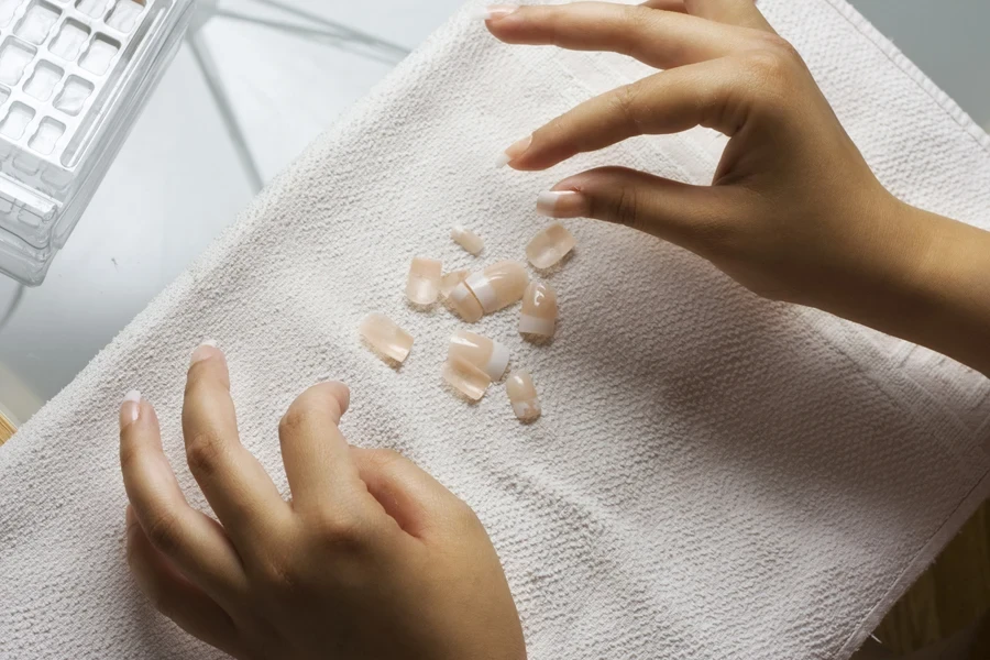 girl removing her fake nails at home