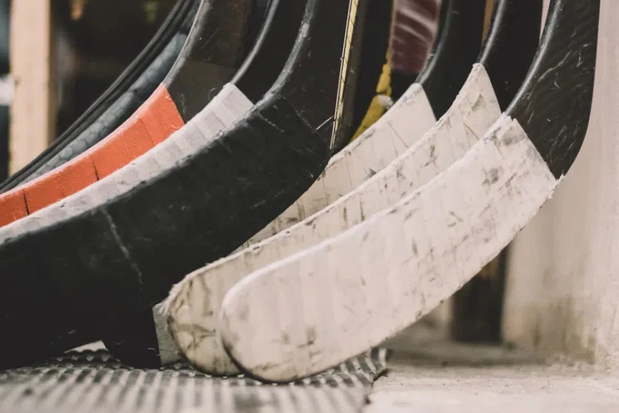 hockey sticks are in the locker room