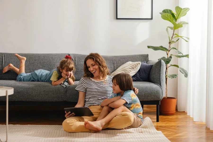 Kids and their mom in a living room with sofa