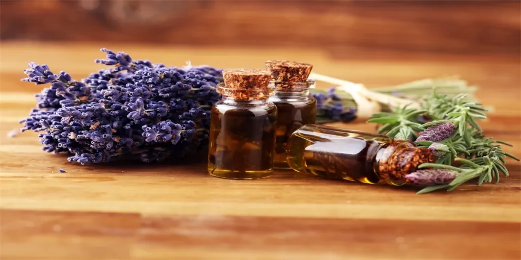 lavender oil in a glass bottle on a background of fresh flowers