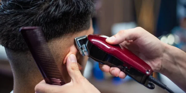 lose up shot of man getting trendy haircut at barber shop