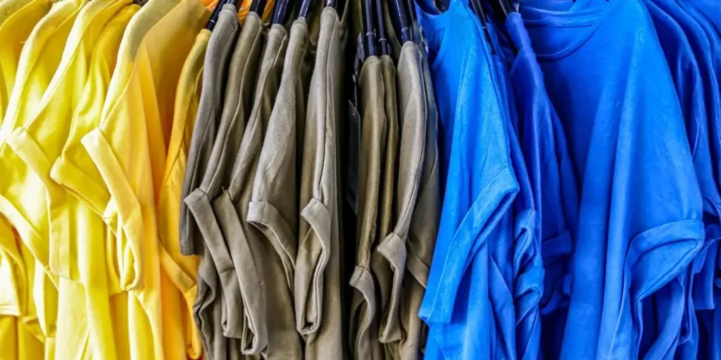 many colored T-shirts hanging on the hanger