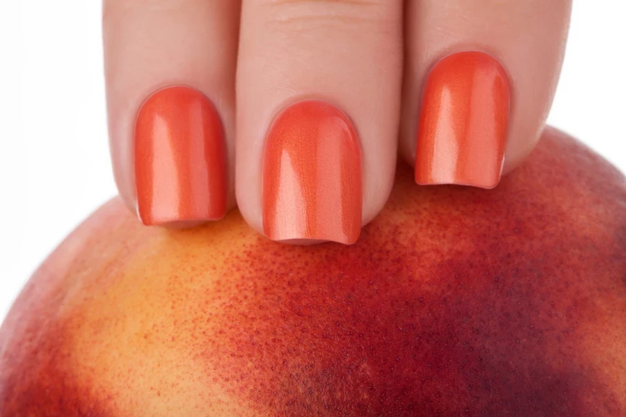 peach nails grabbing over a peach