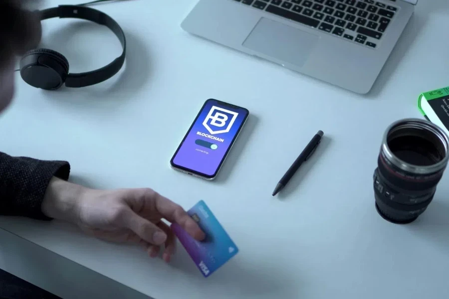 Person holding blue credit card